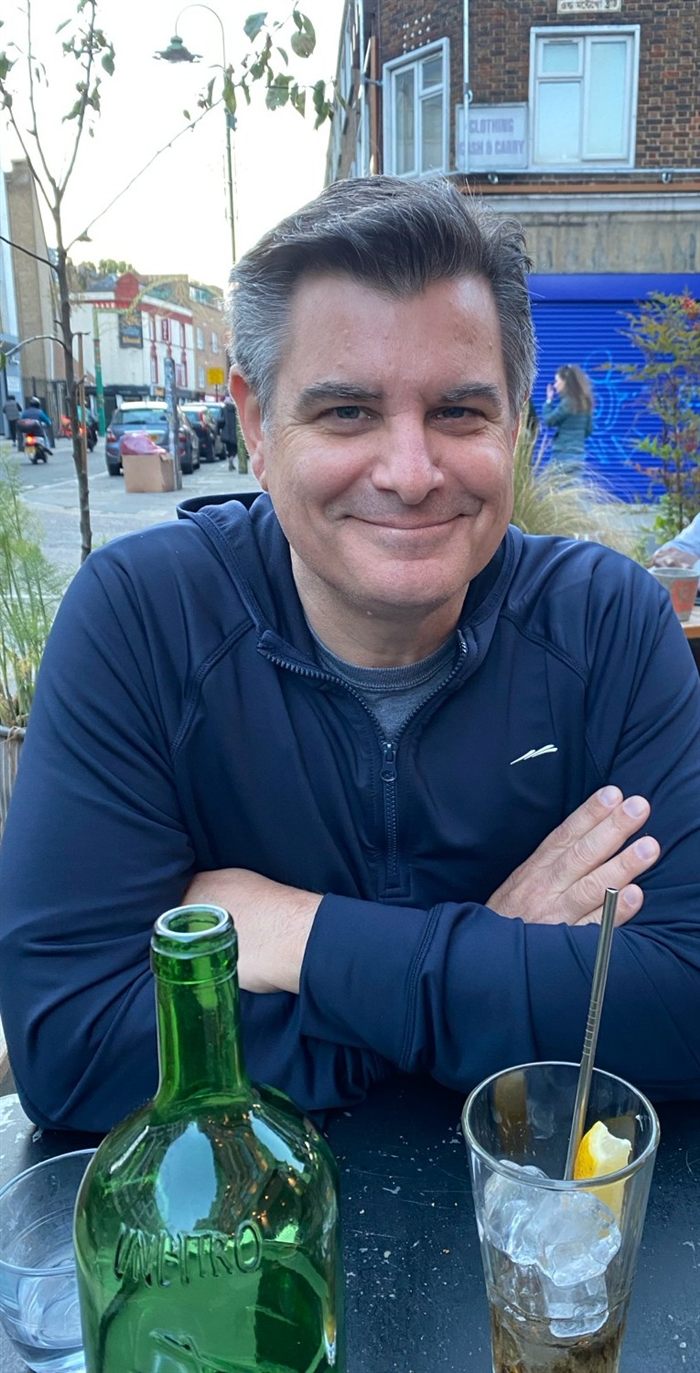 Justin McFarr seated at an outdoor table